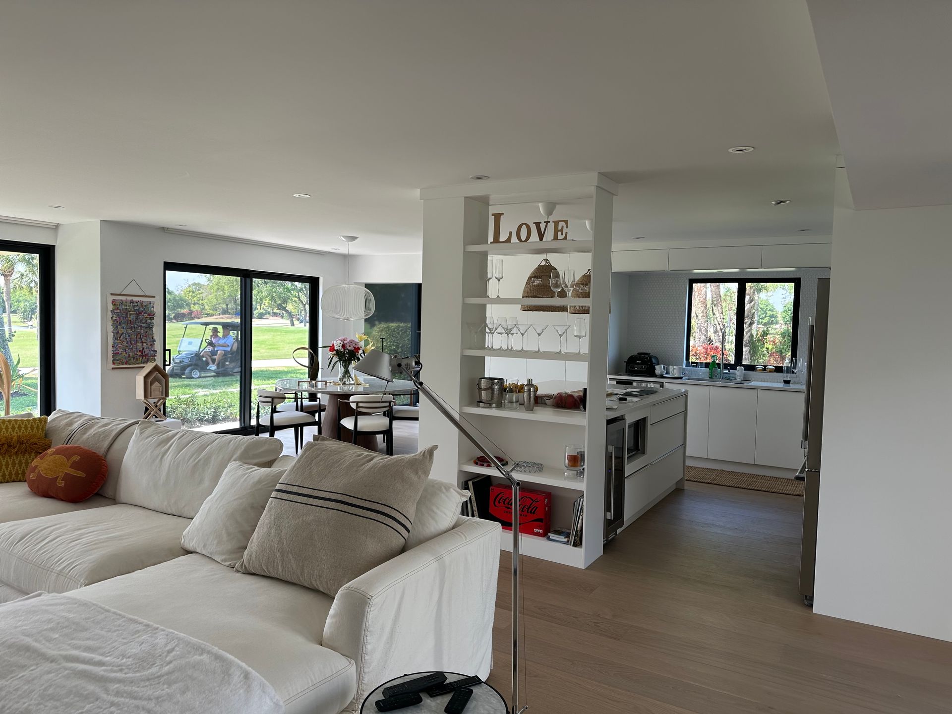 A living room with a couch and a sign that says love.