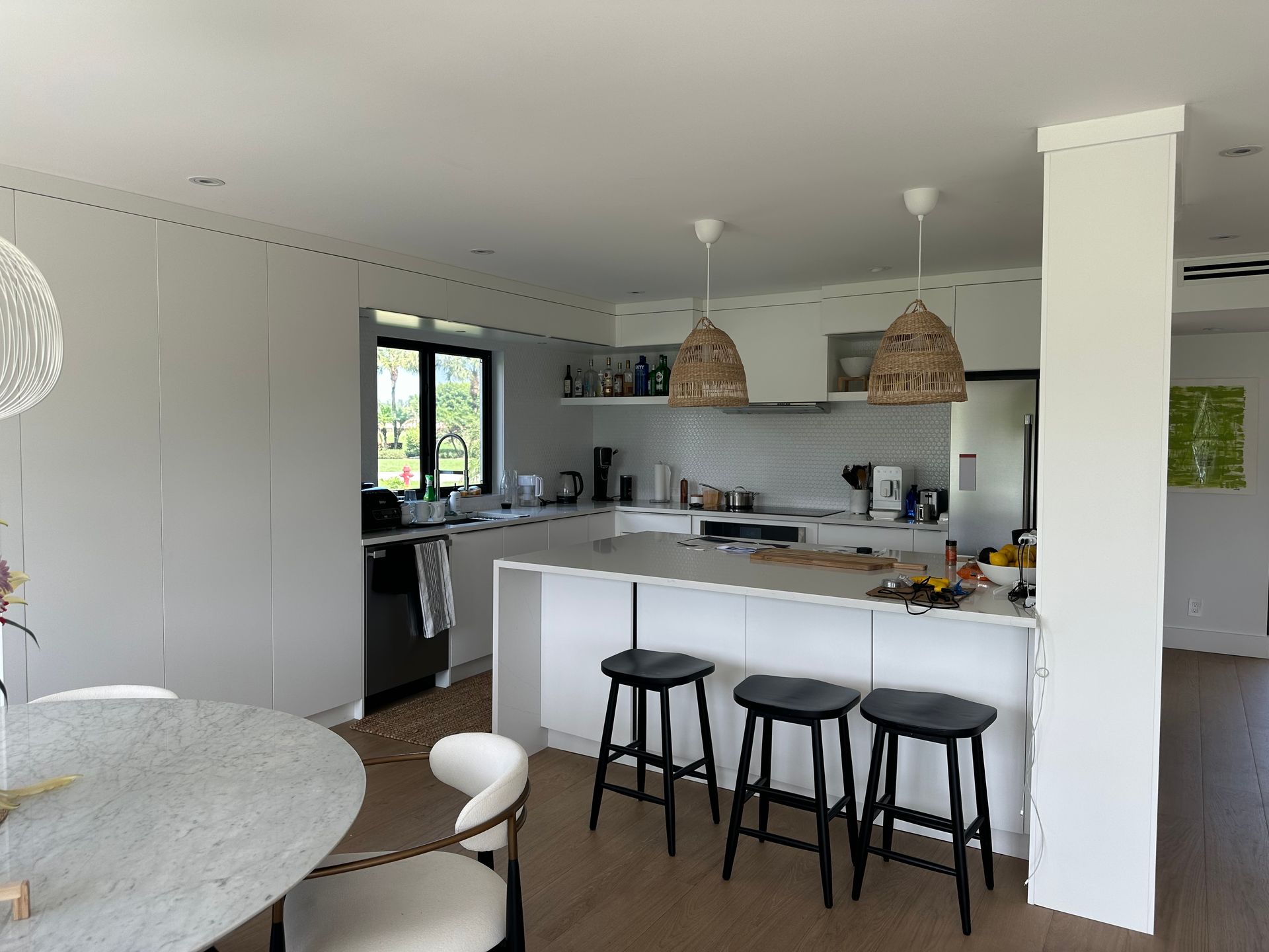A kitchen with a table and stools in it