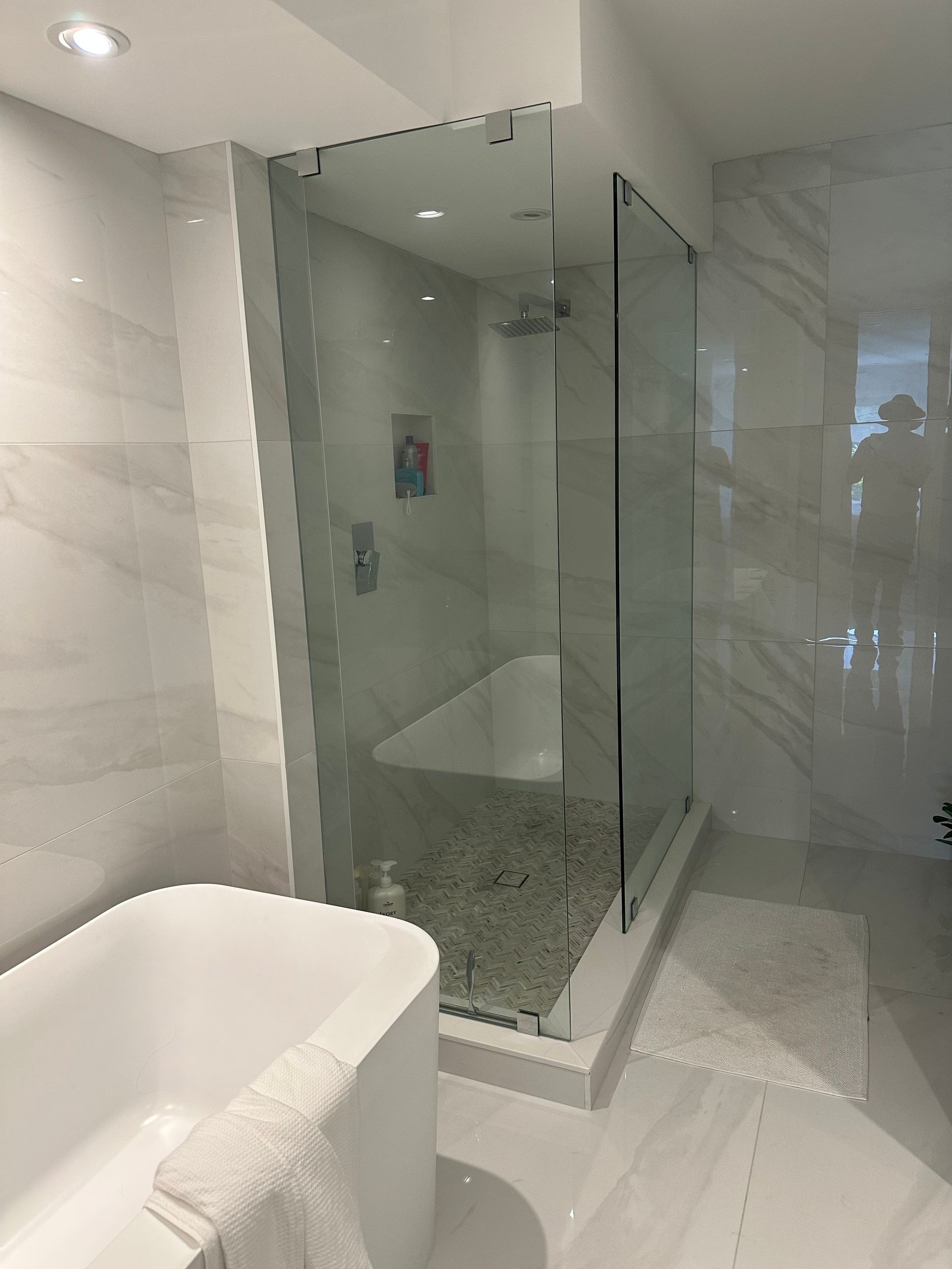 A bathroom with a bathtub and a walk in shower