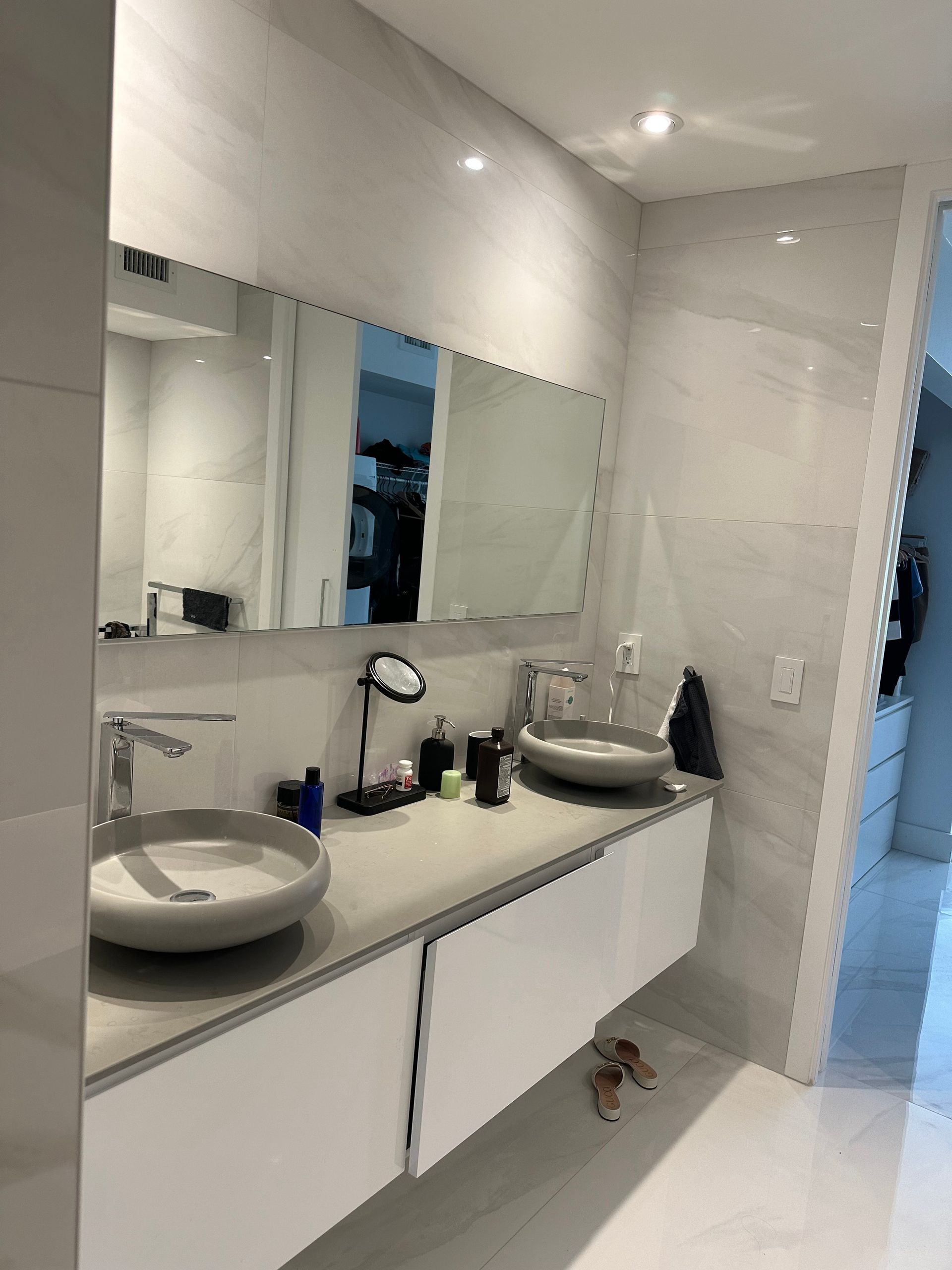 A bathroom with two sinks and a mirror.