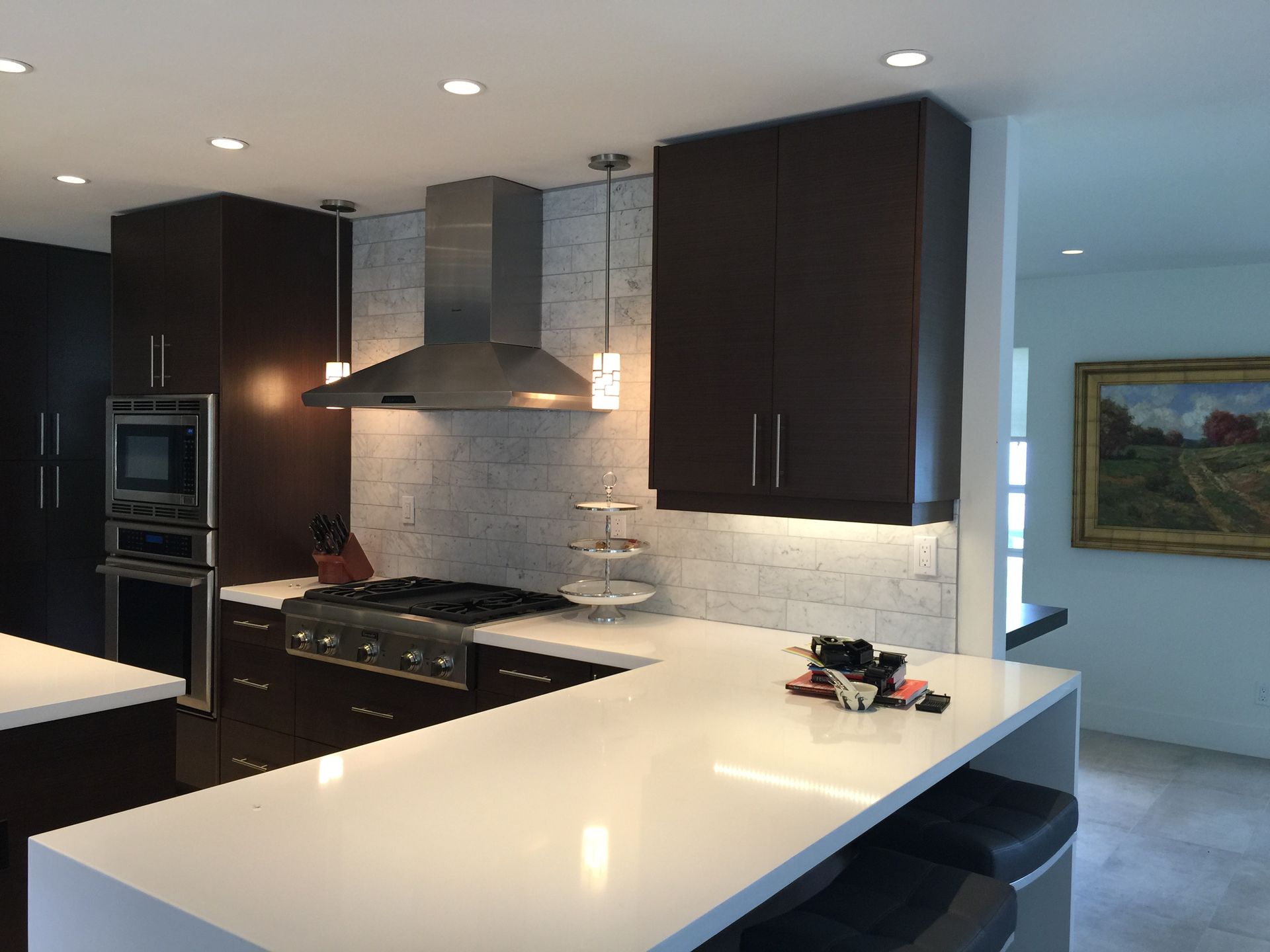 A kitchen with brown cabinets and white counter tops