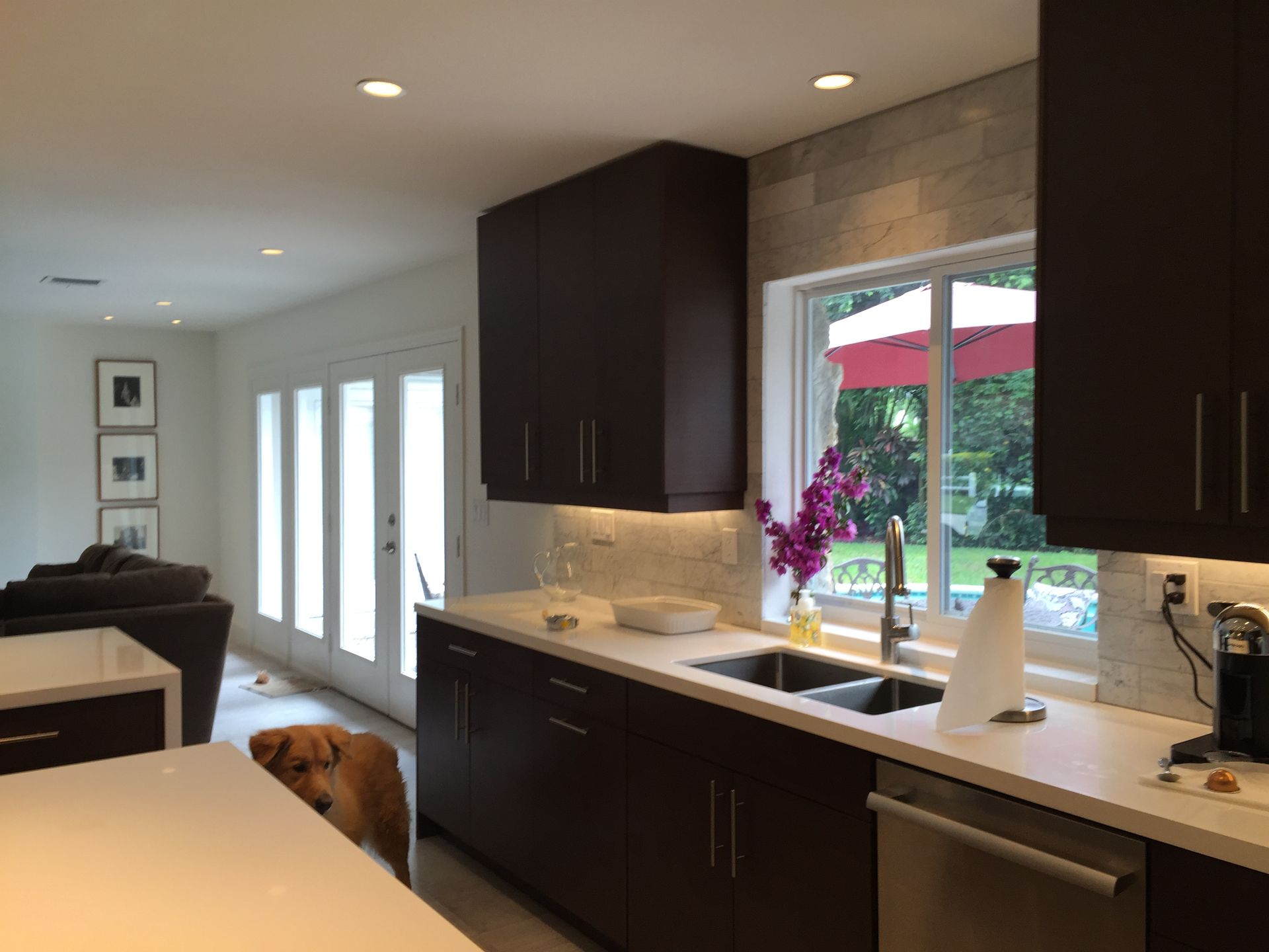 A kitchen with two sinks and a large window