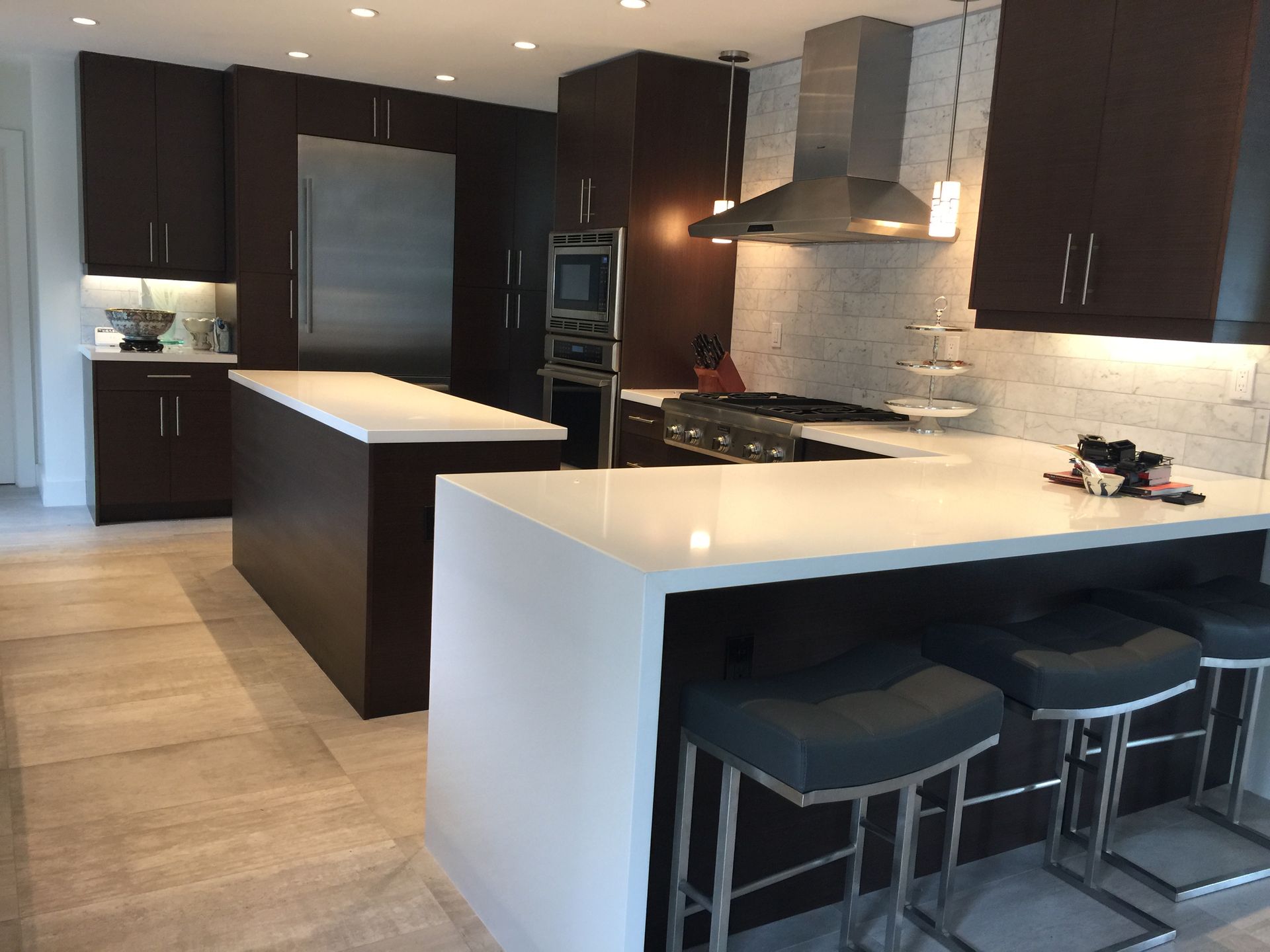 A kitchen with brown cabinets and white counter tops