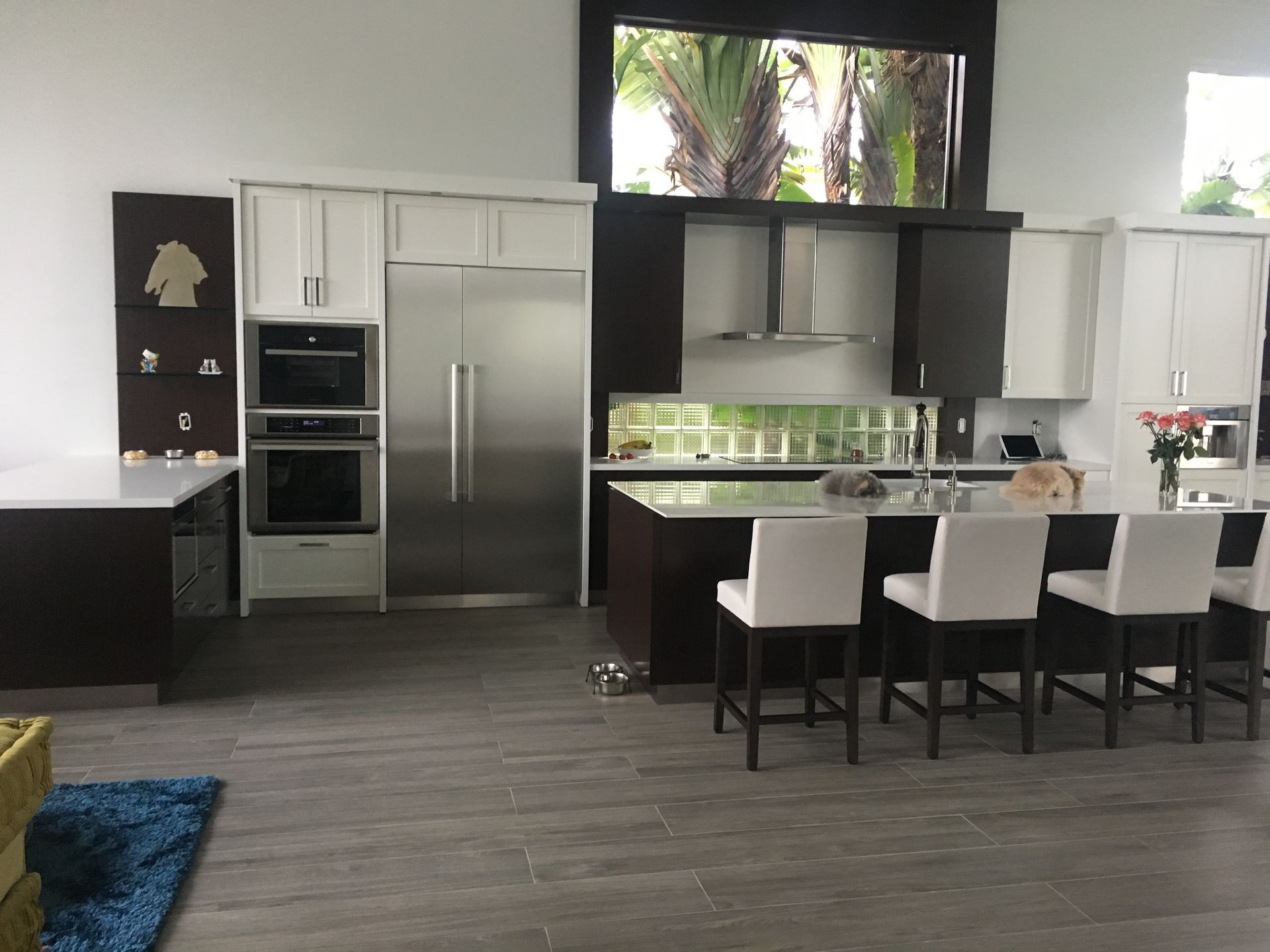 A kitchen with stainless steel appliances and white cabinets