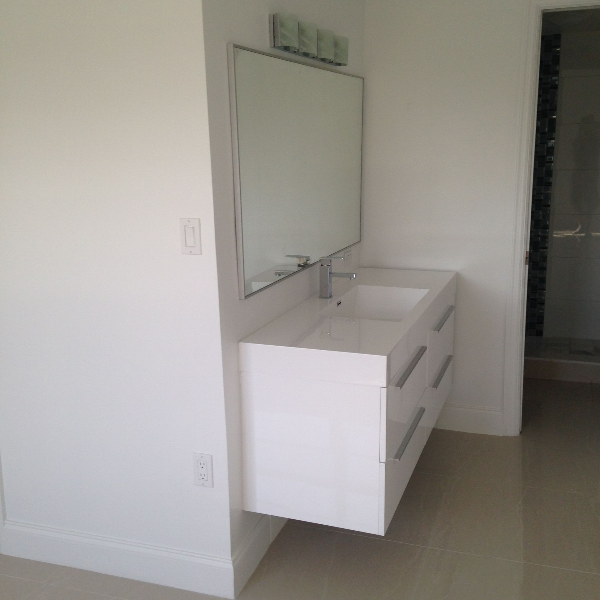 A bathroom with a sink and a large mirror