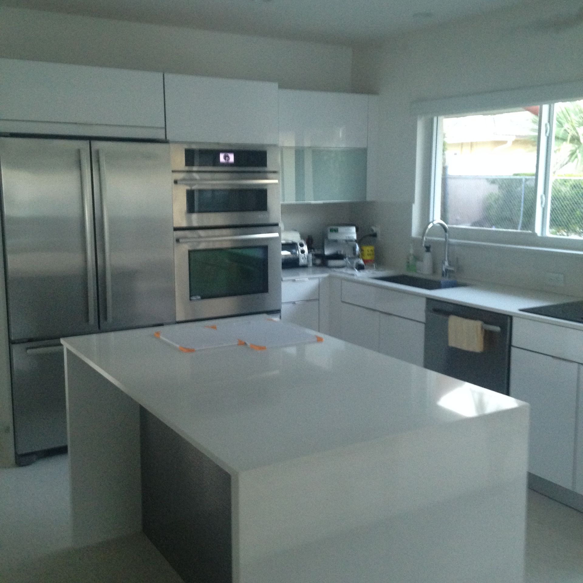 A kitchen with stainless steel appliances and white cabinets