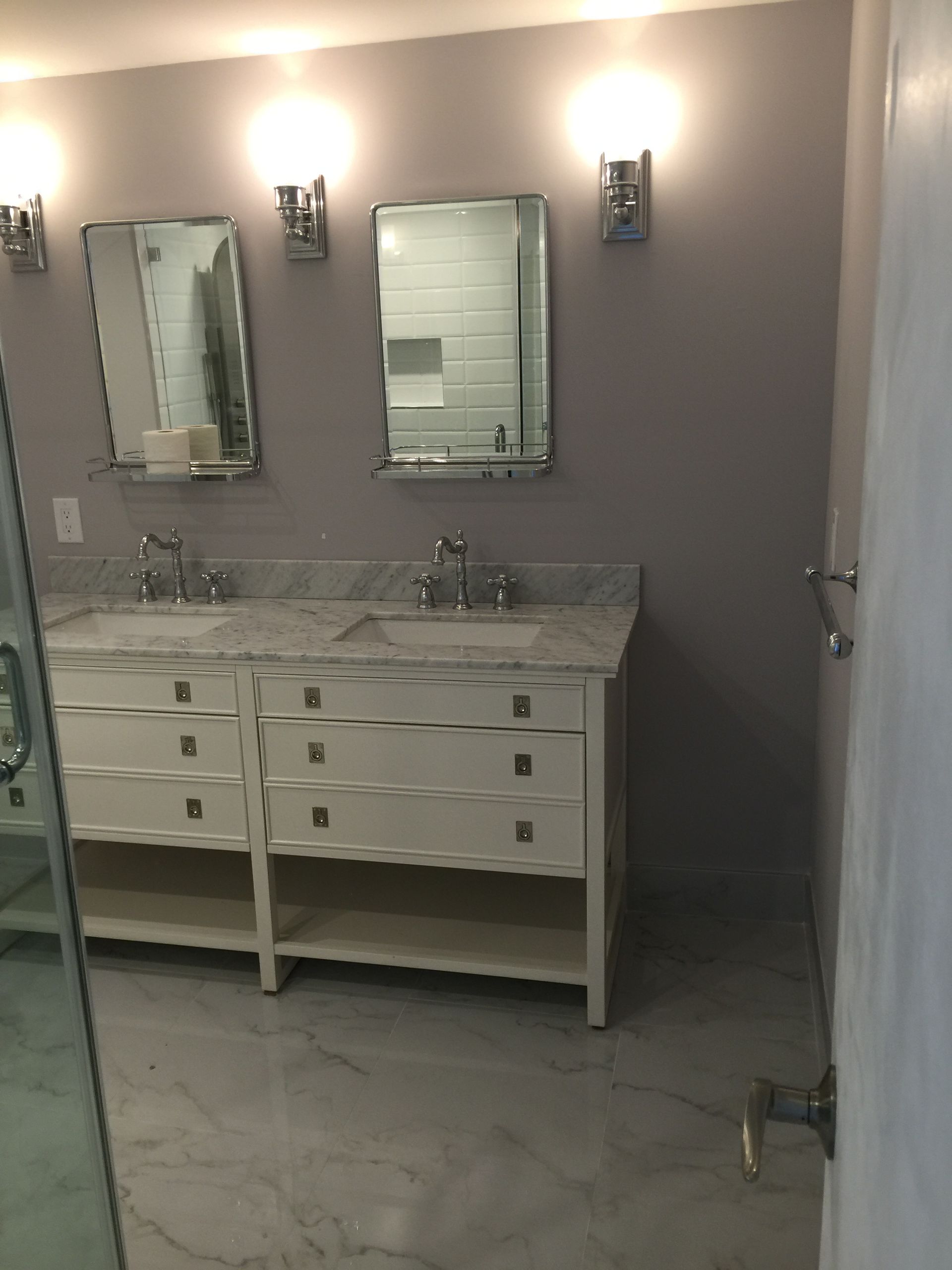 A bathroom with two sinks and two mirrors.