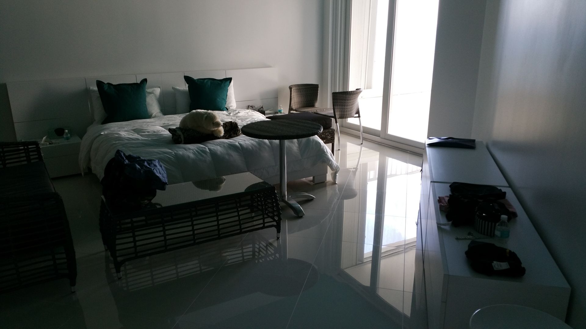 A bedroom with a bed and a table in it