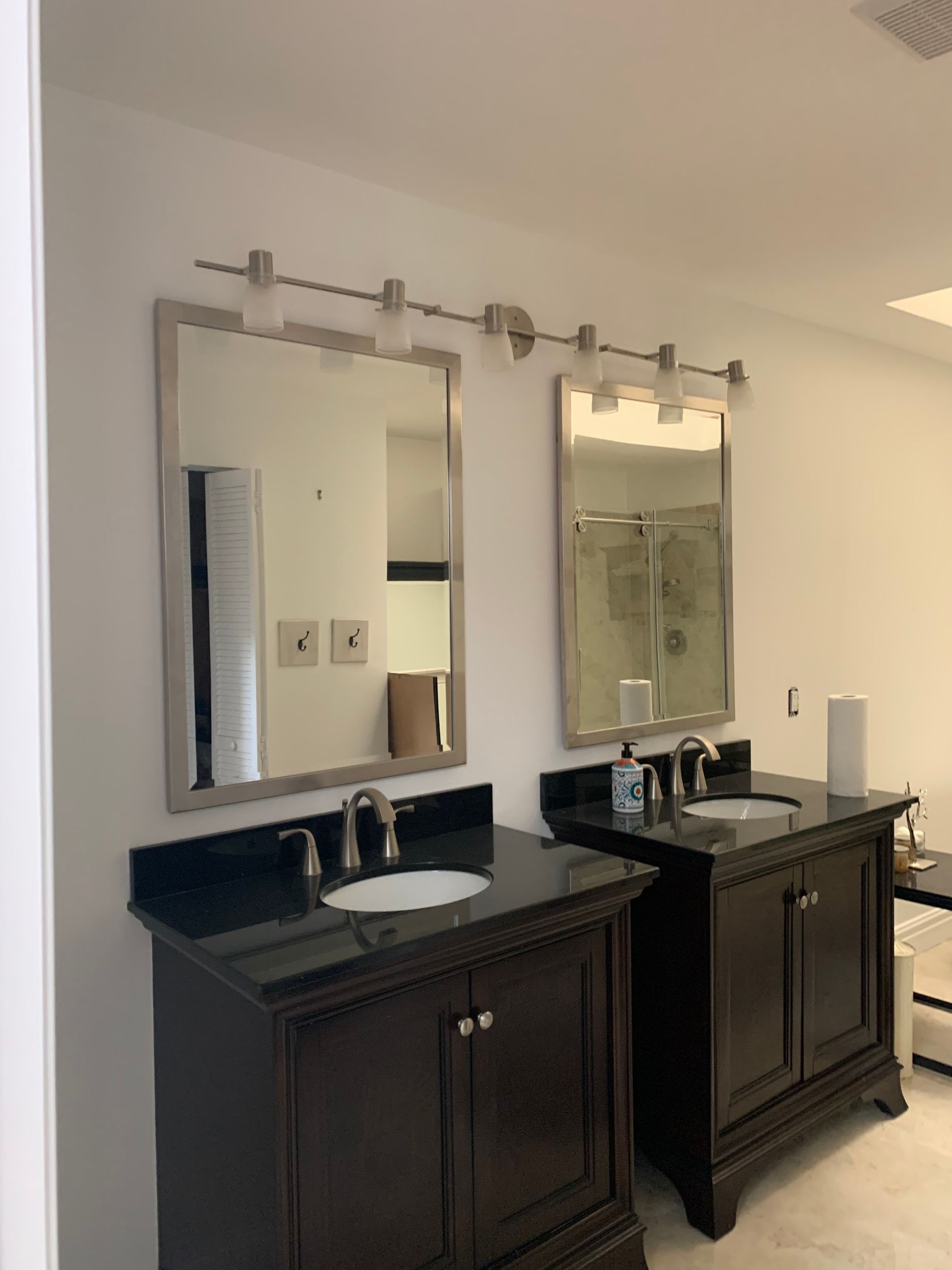 A bathroom with two sinks and two mirrors