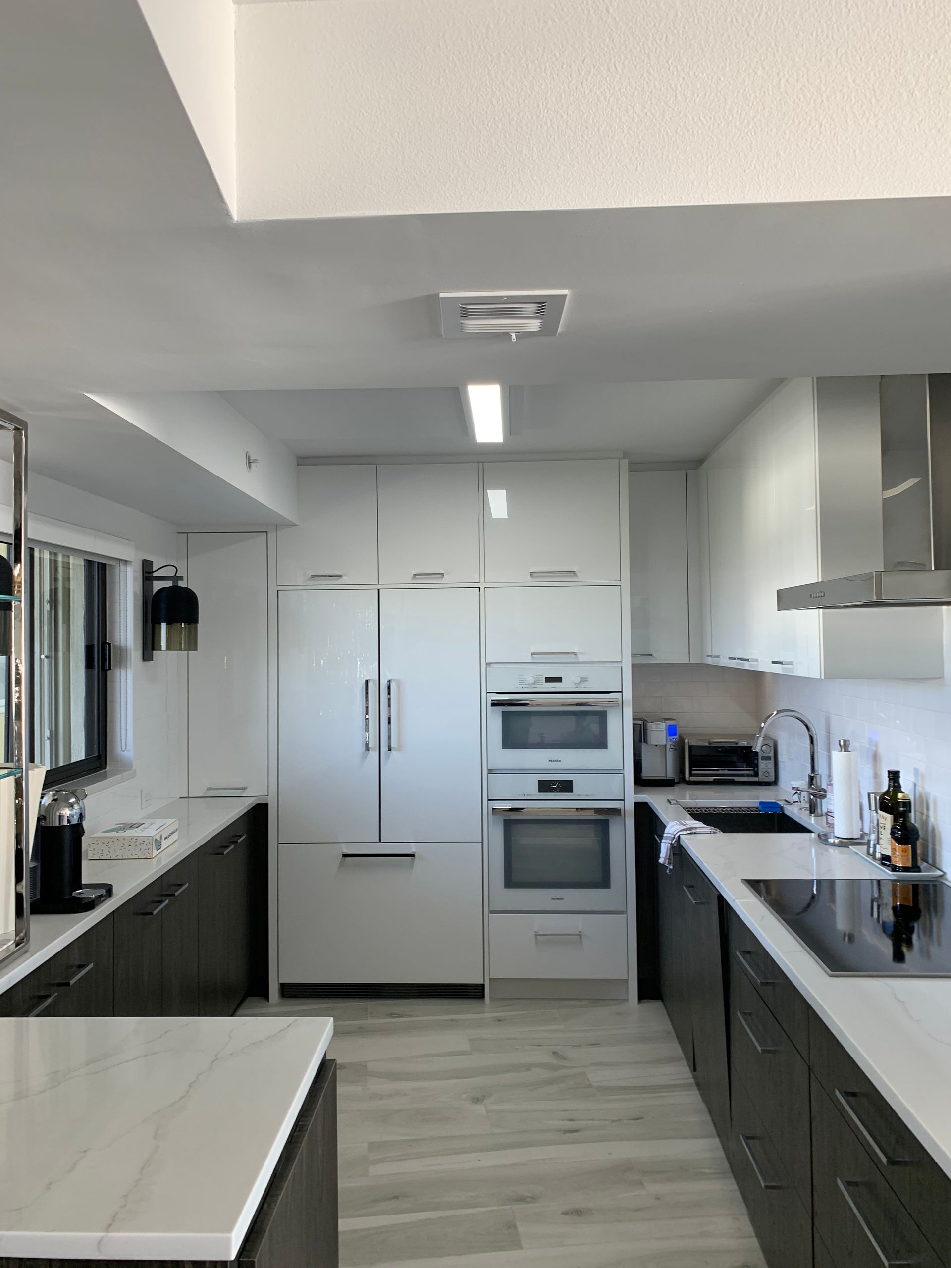 A kitchen with white cabinets and stainless steel appliances