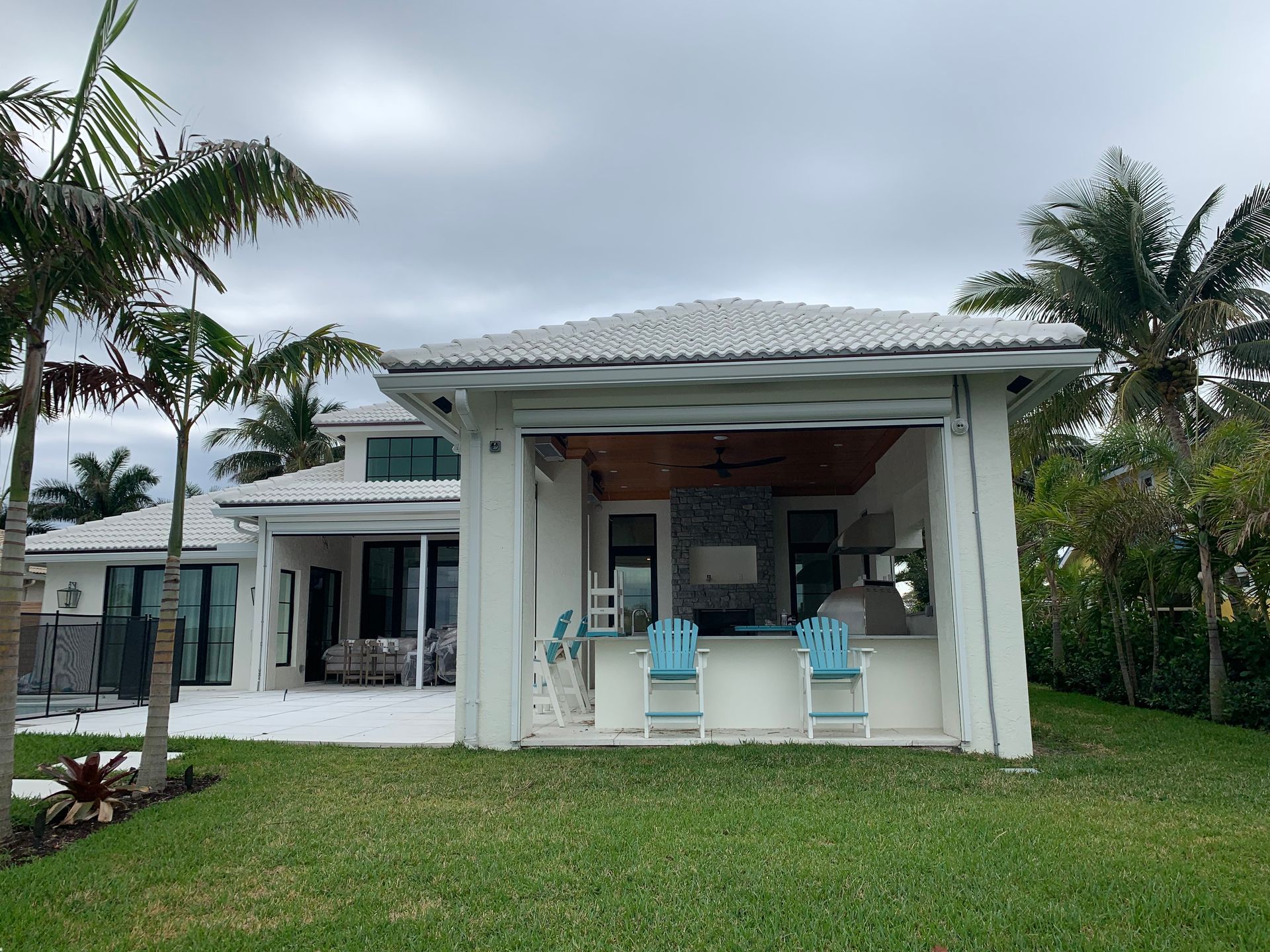 A white house with a sliding glass door leading to a patio area.