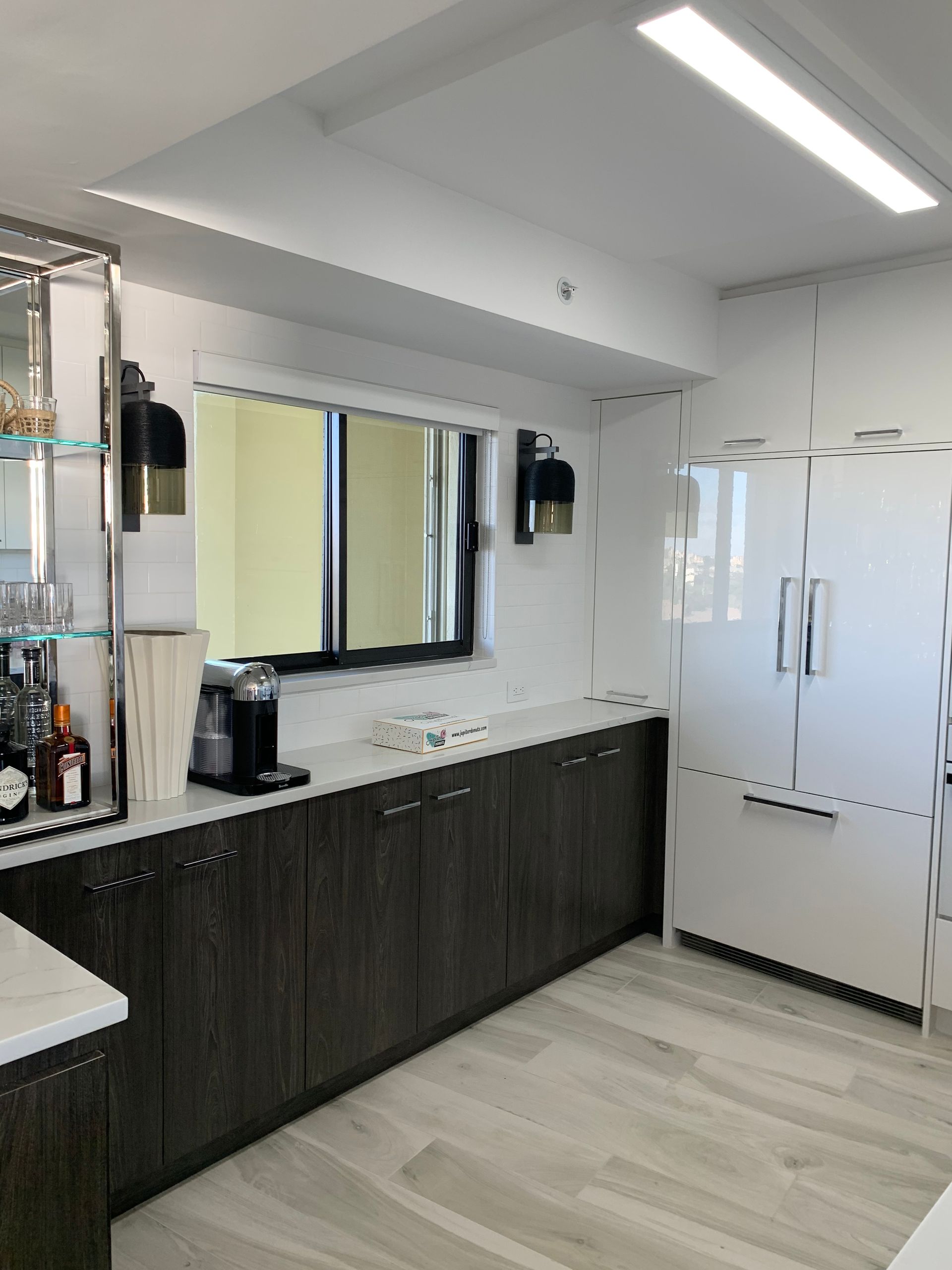 A kitchen with a lot of cabinets and a refrigerator