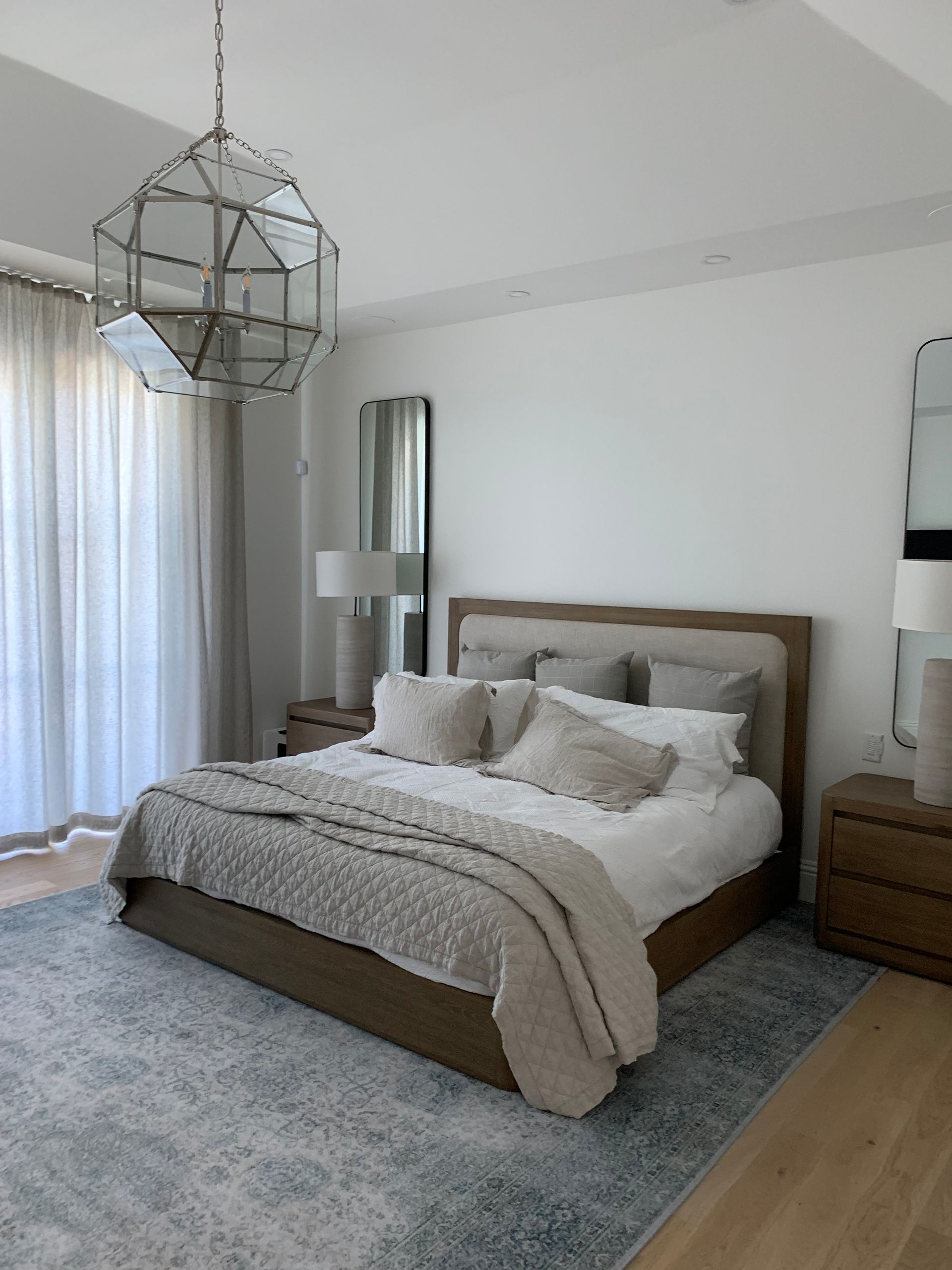 A bedroom with a large bed and a rug