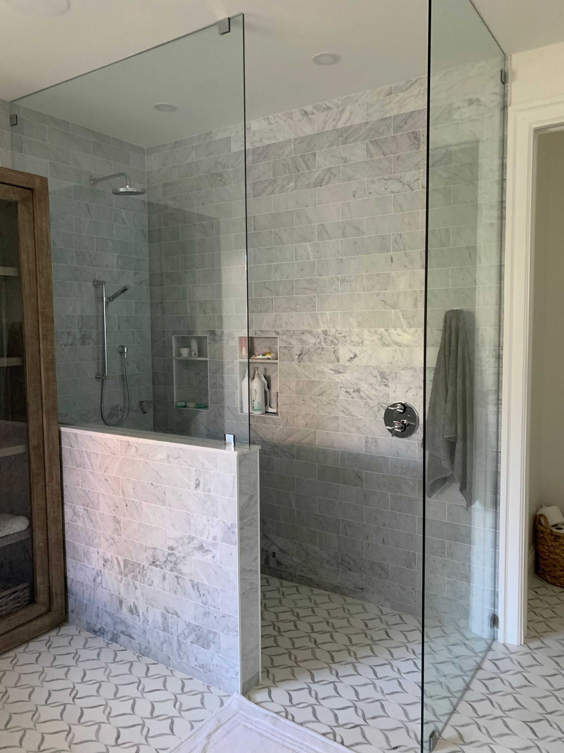 A bathroom with a walk in shower and a sauna.