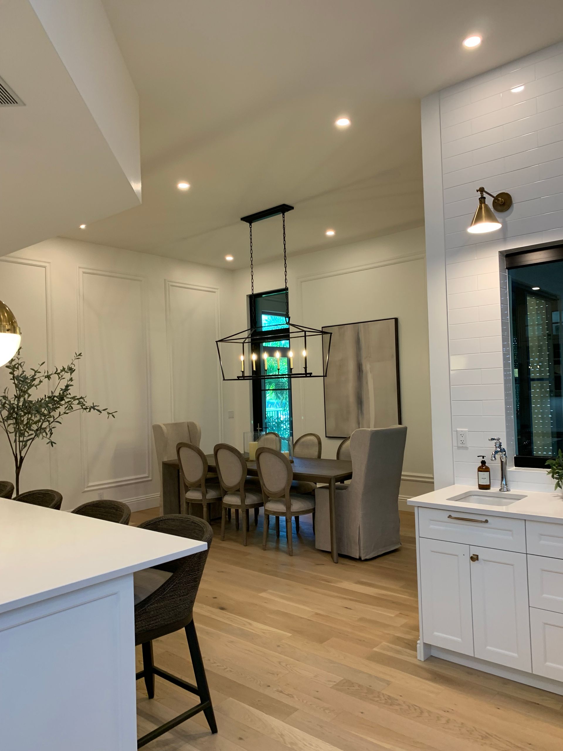 A kitchen with a table and chairs and a refrigerator