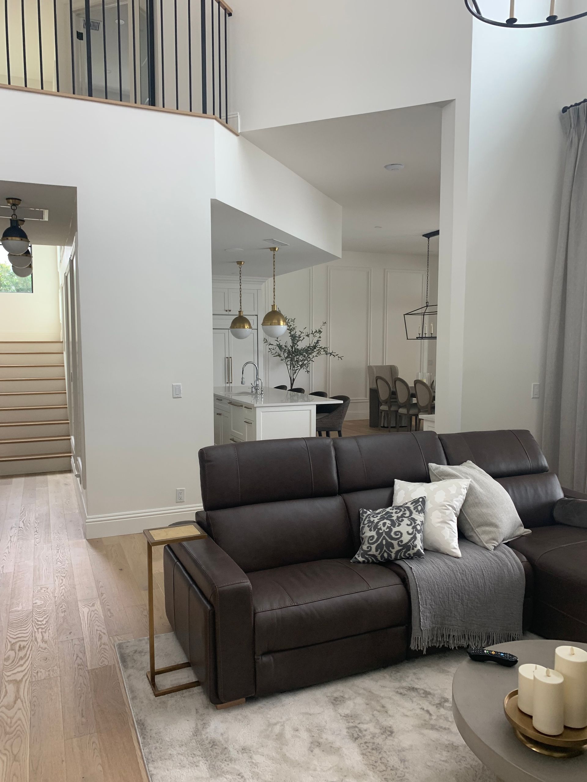 A living room with a brown couch and a coffee table