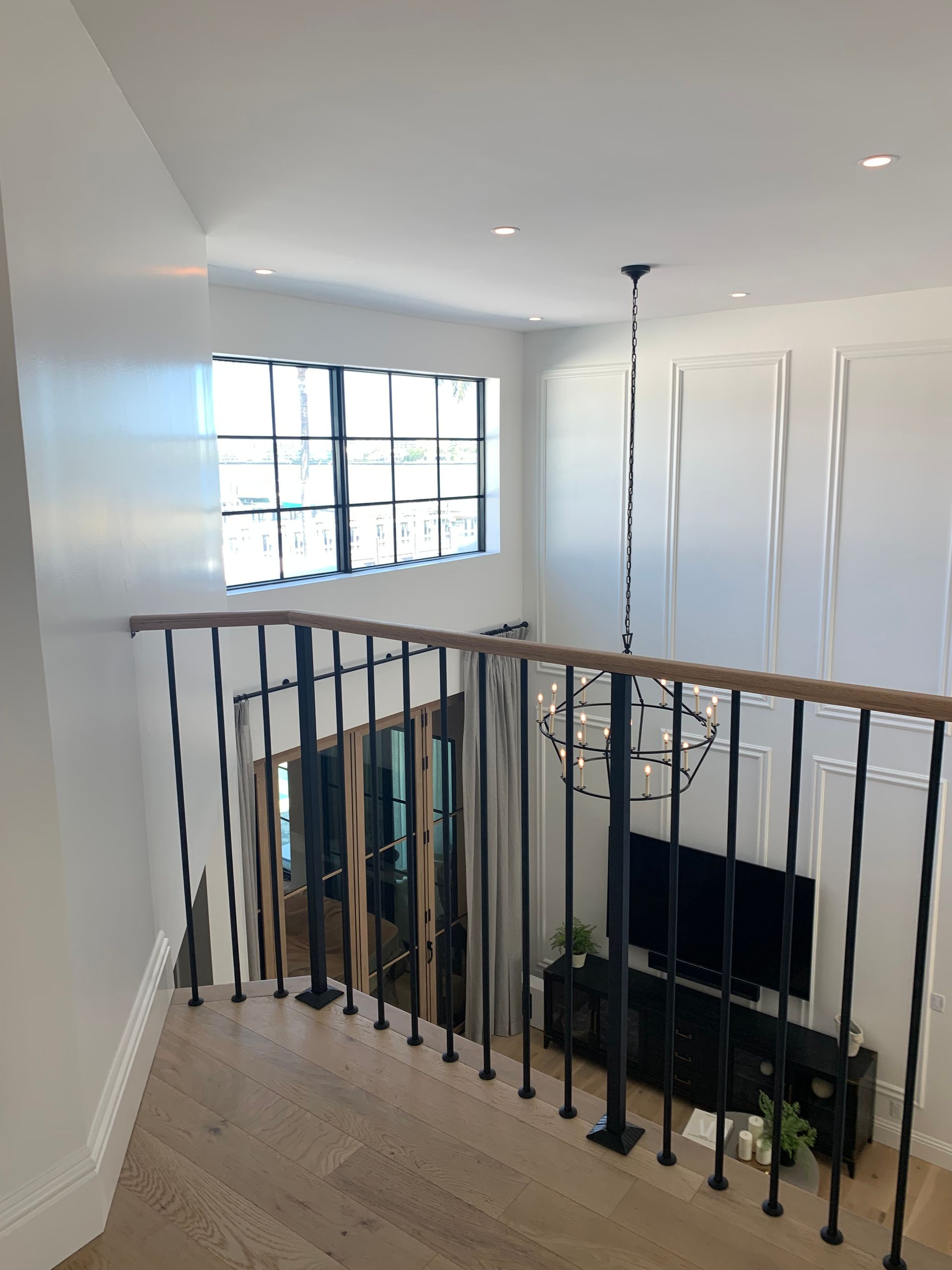 A living room with a staircase leading up to the second floor