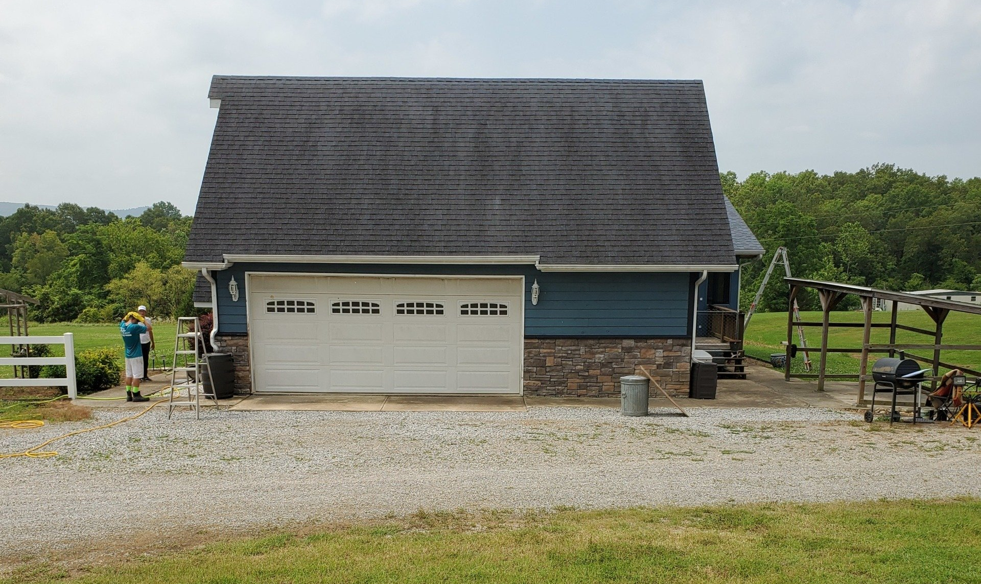 A large white garage door is sitting in front of a house.