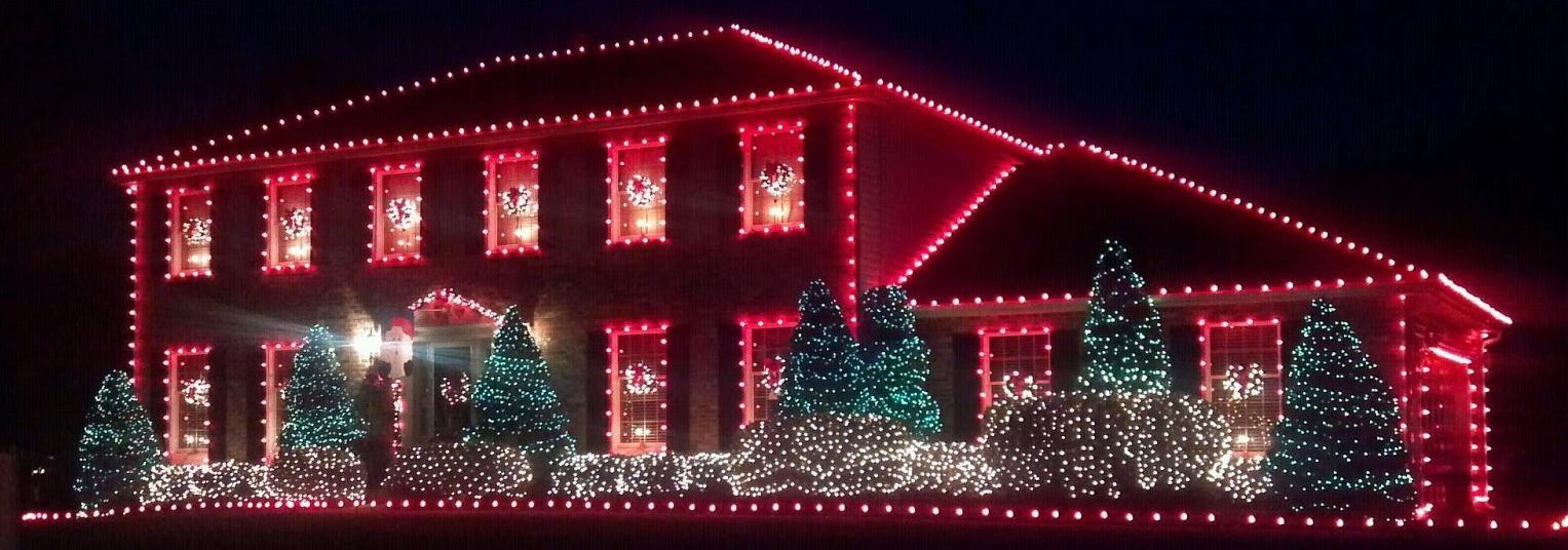 A house is lit up with red and green christmas lights