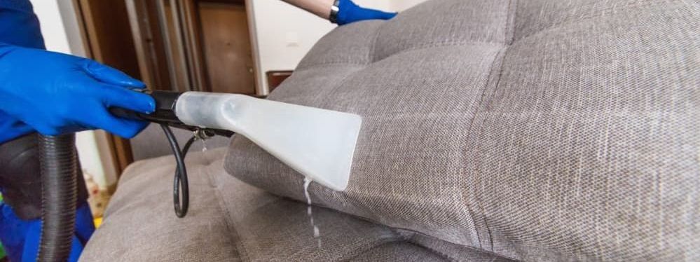 Professional Upholstery Cleaning A couch and cushions with a professional upholstery cleaning machine.