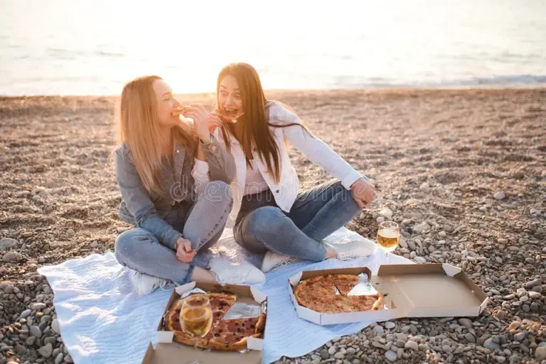 Two Women Enjoying Pizza and Drinks — Stoked Pizza in Helensvale, QLD