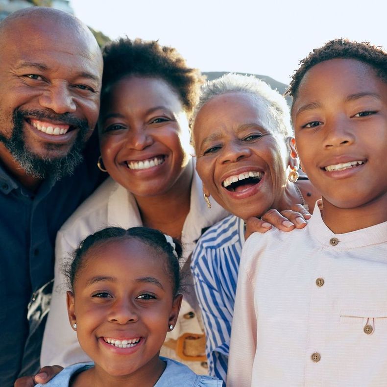 A group of people are posing for a picture together and smiling.