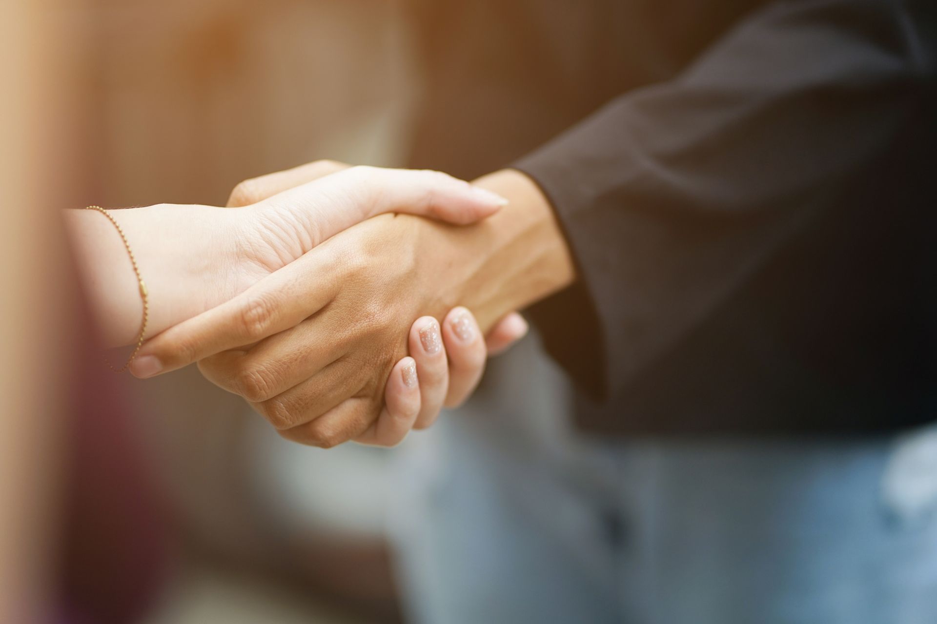 A close up of two people shaking hands.