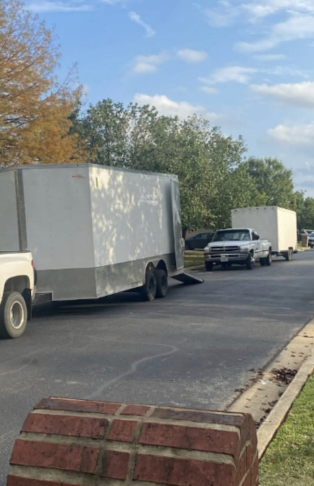 A row of trailers are parked on the side of the road.