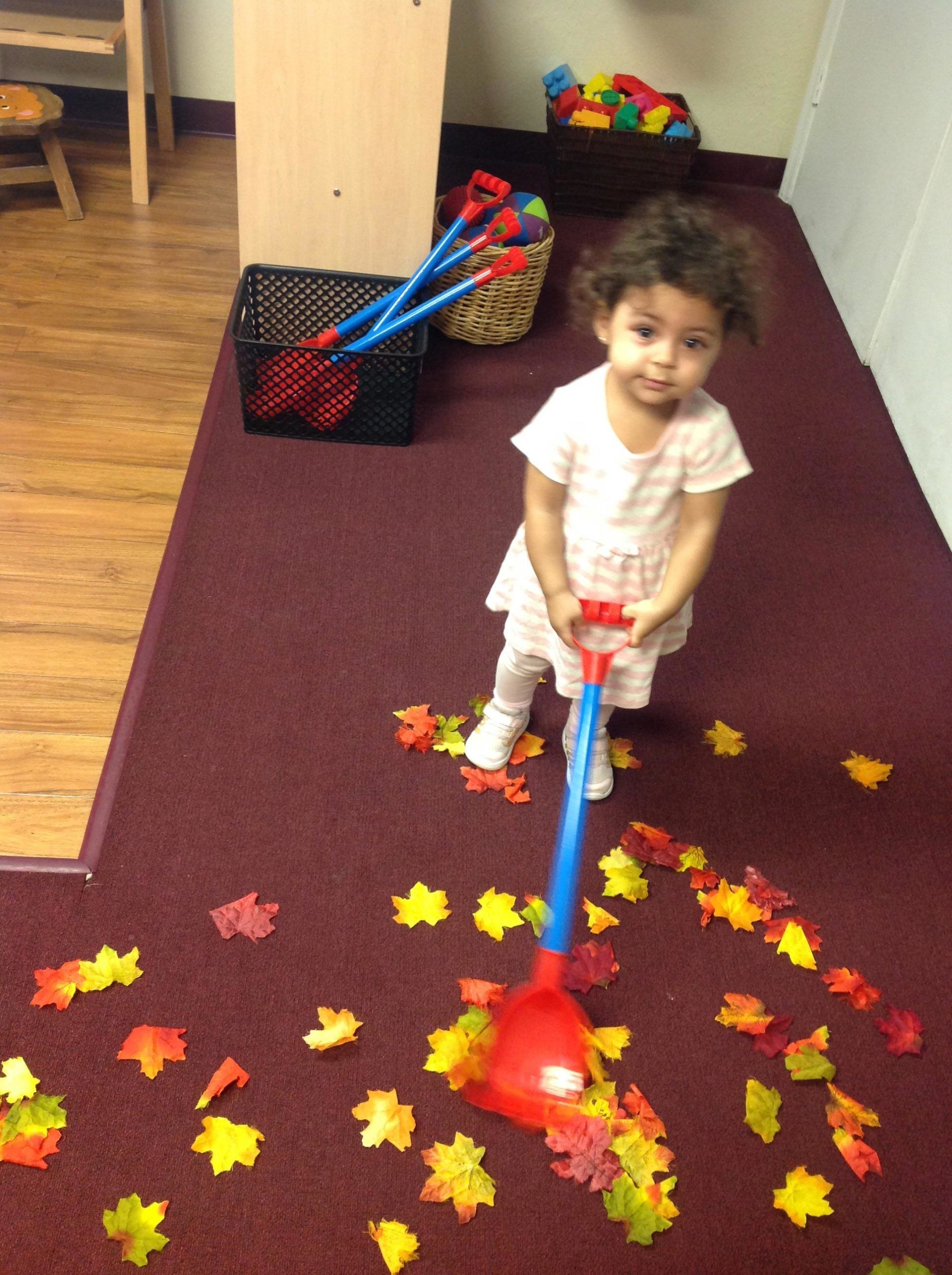 Little Girl Playing with Leaves — Bradenton, FL — Palma Sola Early Learning Academy