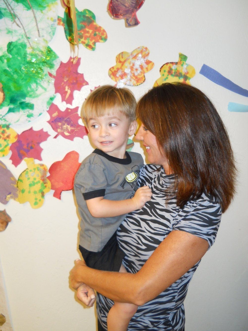 Teacher Holding a Young Boy — Bradenton, FL — Palma Sola Early Learning Academy
