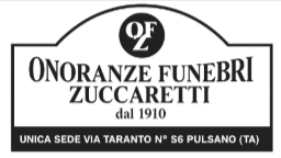 Black-and-white sign for Onoranze Funebri Zuccaretti, with address in Pulsano, Italy.
