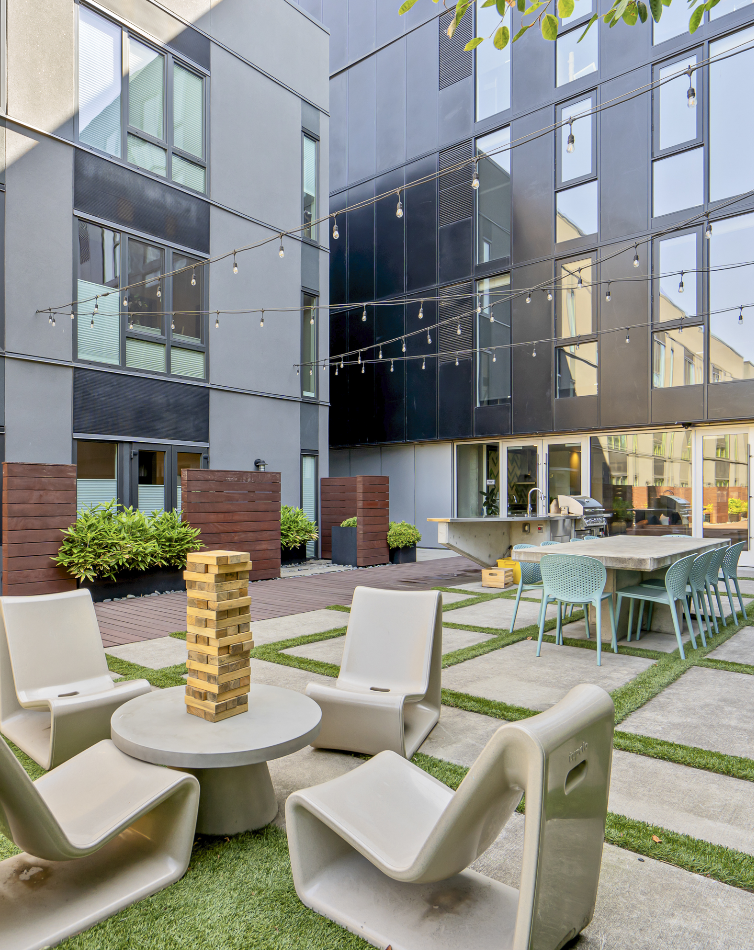 A courtyard with chairs and a table in front of a building