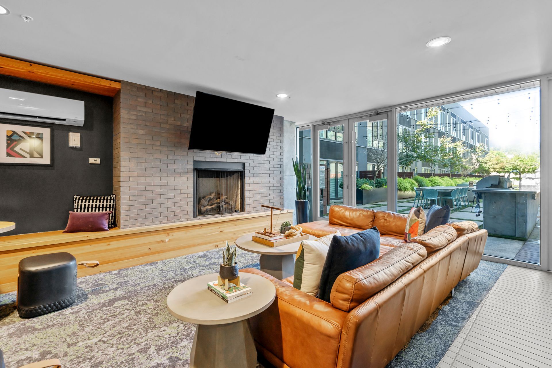 A living room with a couch , table , fireplace and television.