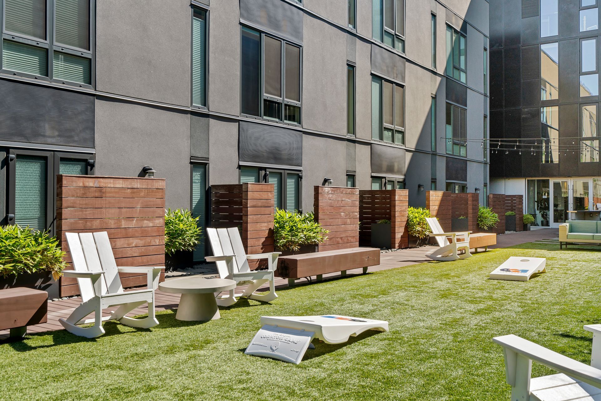 A lawn with chairs and a table in front of a building