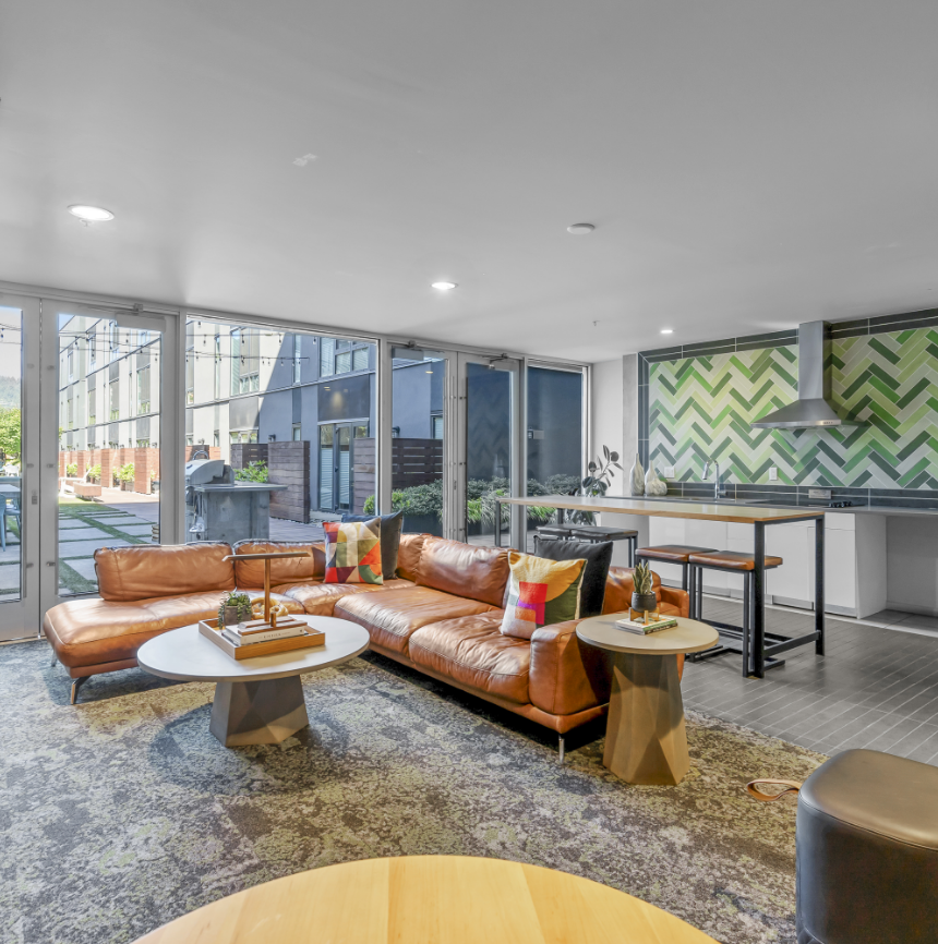 A living room with a couch , table , and chairs.