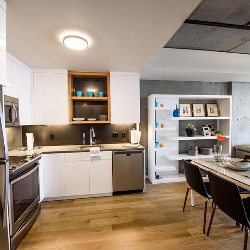 A kitchen with white cabinets and stainless steel appliances