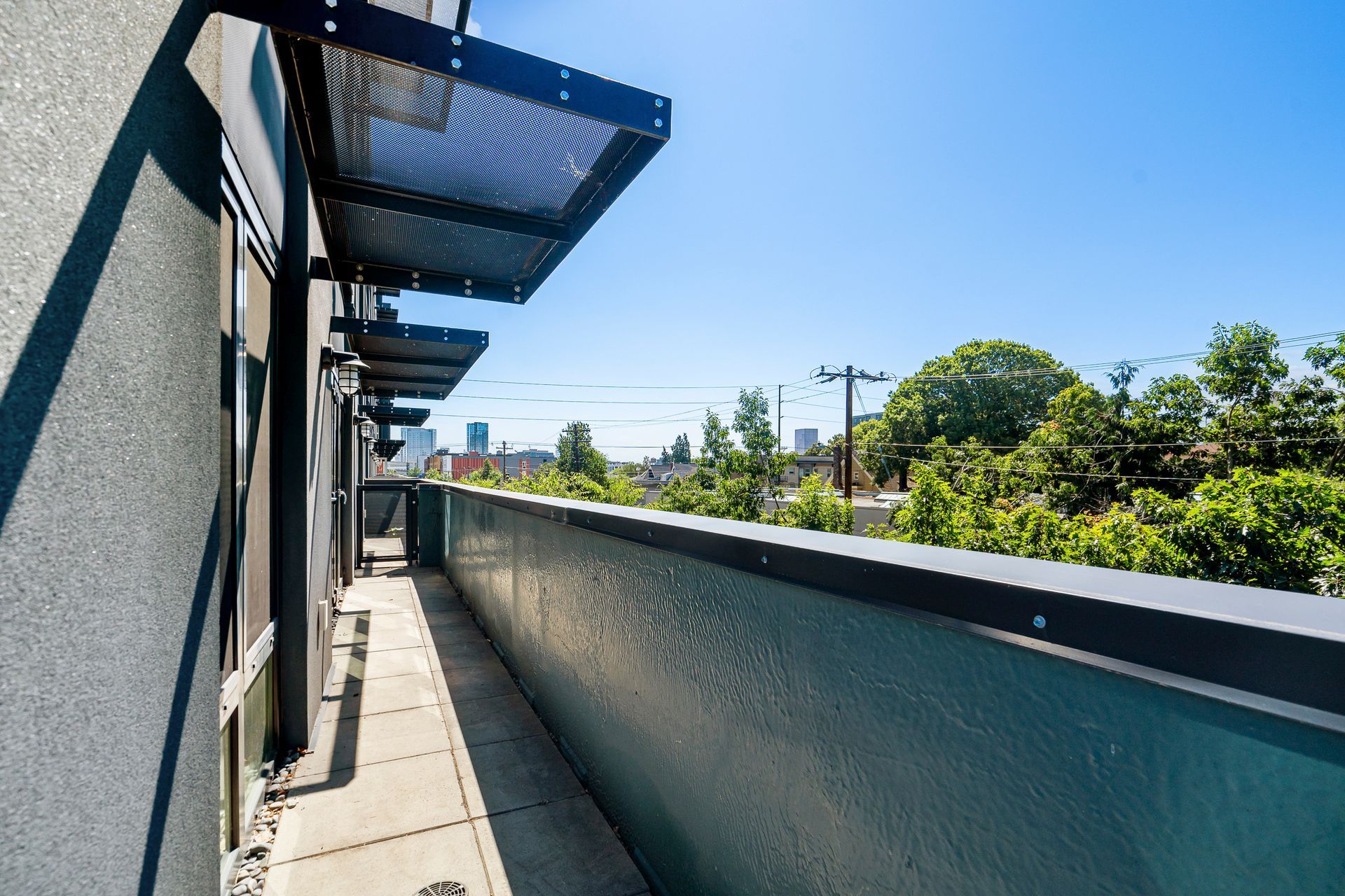 A balcony on the side of a building with a canopy over it.