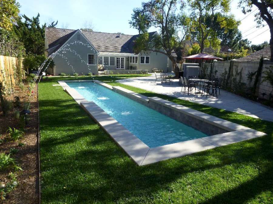 A large swimming pool in the backyard of a house