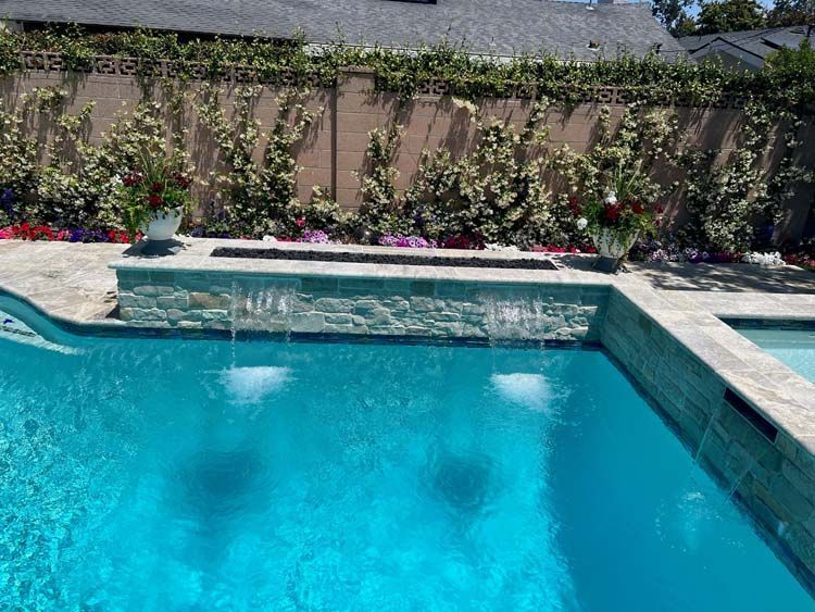 A swimming pool with a waterfall in the middle of it
