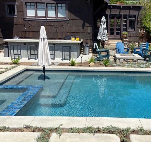 A large swimming pool in front of a house