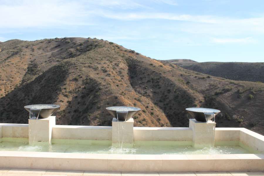 A fountain with a view of mountains in the background