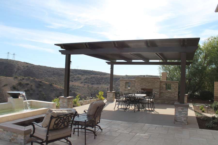 A patio with a table and chairs under a pergola
