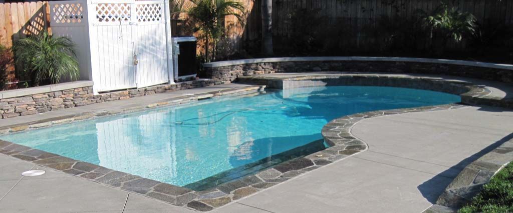 A large swimming pool with a white shed in the background