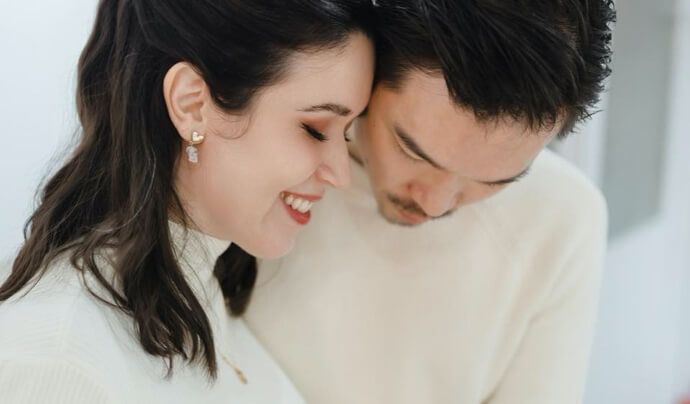 A man and a woman are looking at each other and smiling.