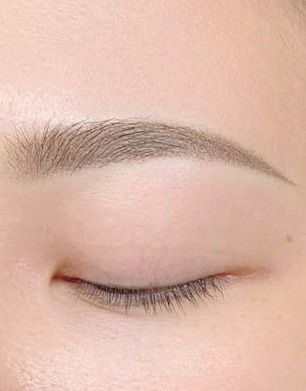 A close up of a woman 's eye with her eyes closed.