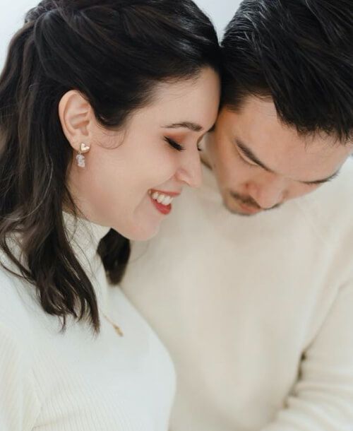 A man and a woman are looking at each other and smiling