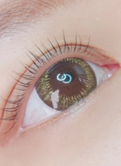 A close up of a woman 's eye with a s on it