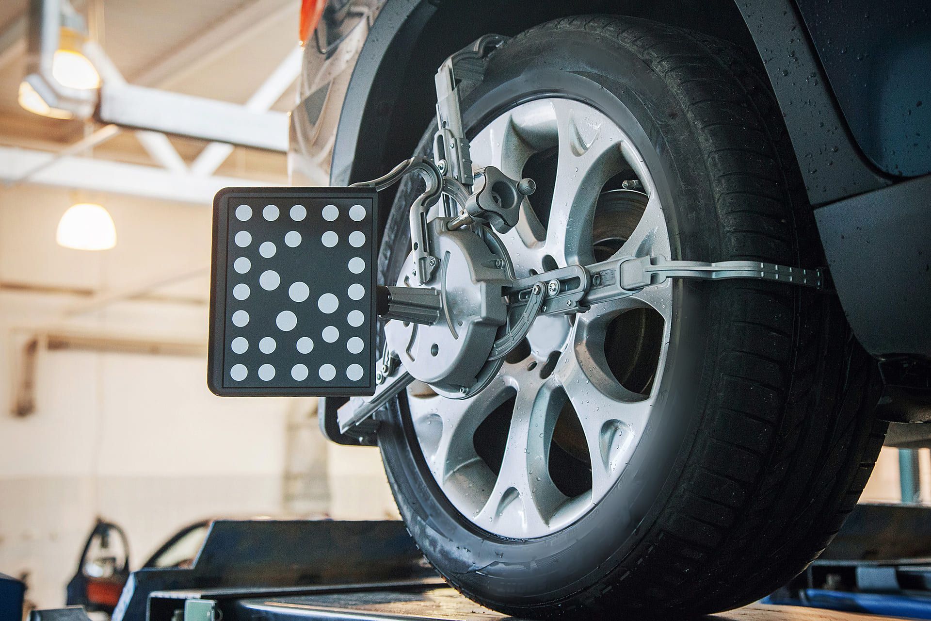 car repair: wheel replacement closeup. mechanic screwing or unscrewing car wheel at car service garage