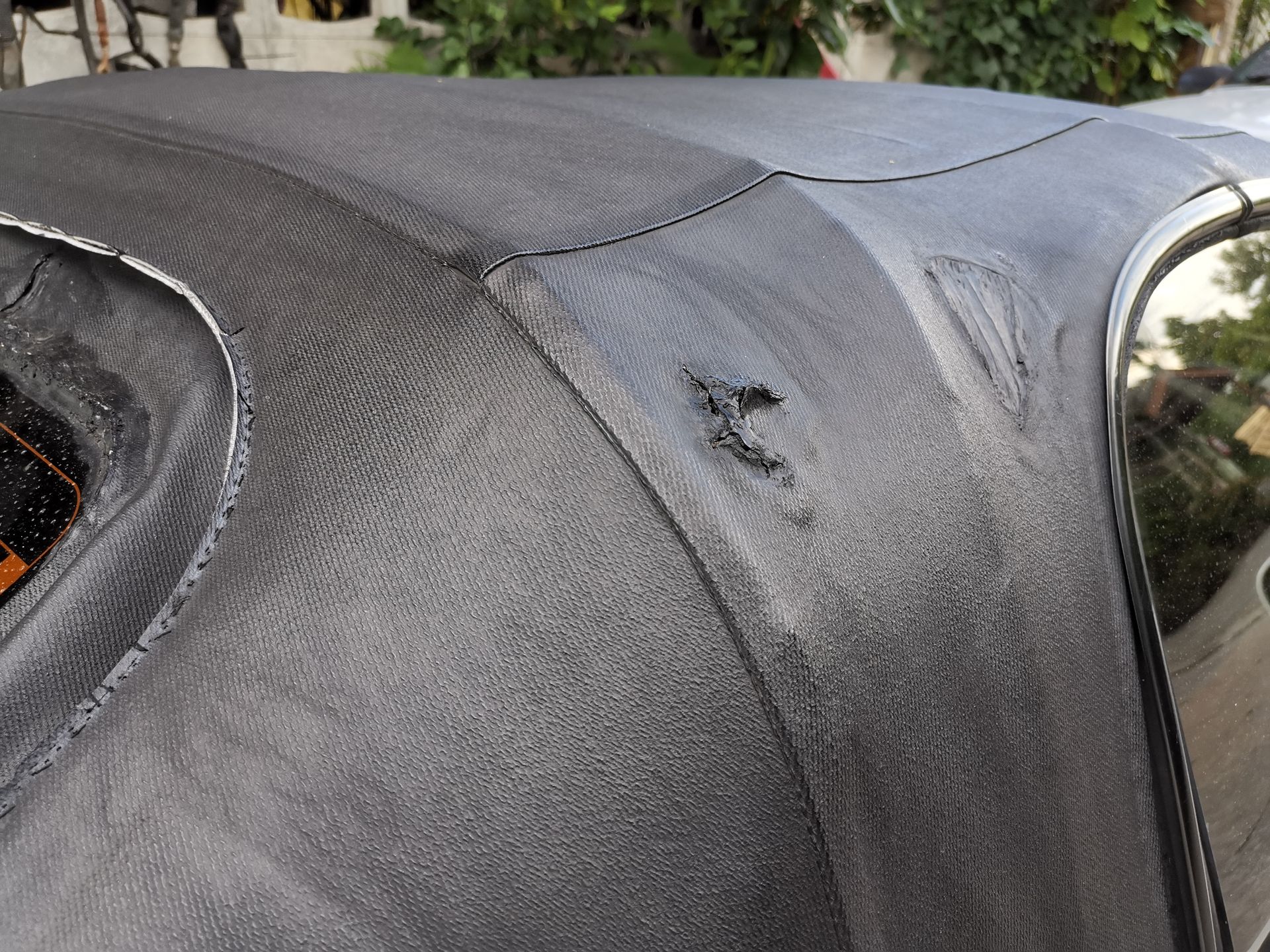 A close up of the roof of a car with a hole in it.