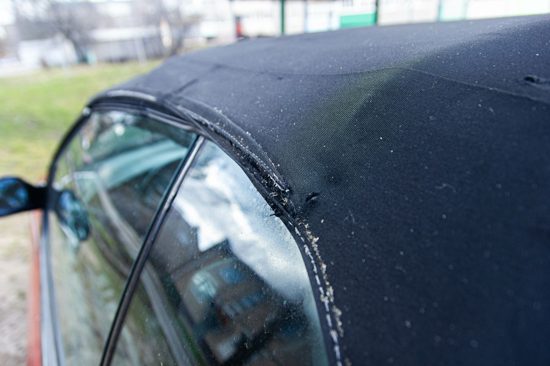 A close up of a car 's roof with a hole in it.